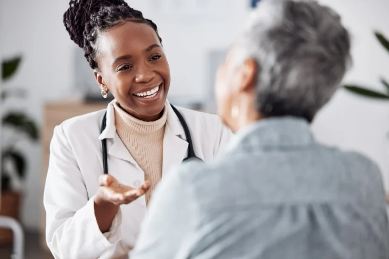 Primary care doctor in San Diego speaking with a patient during a routine visit.