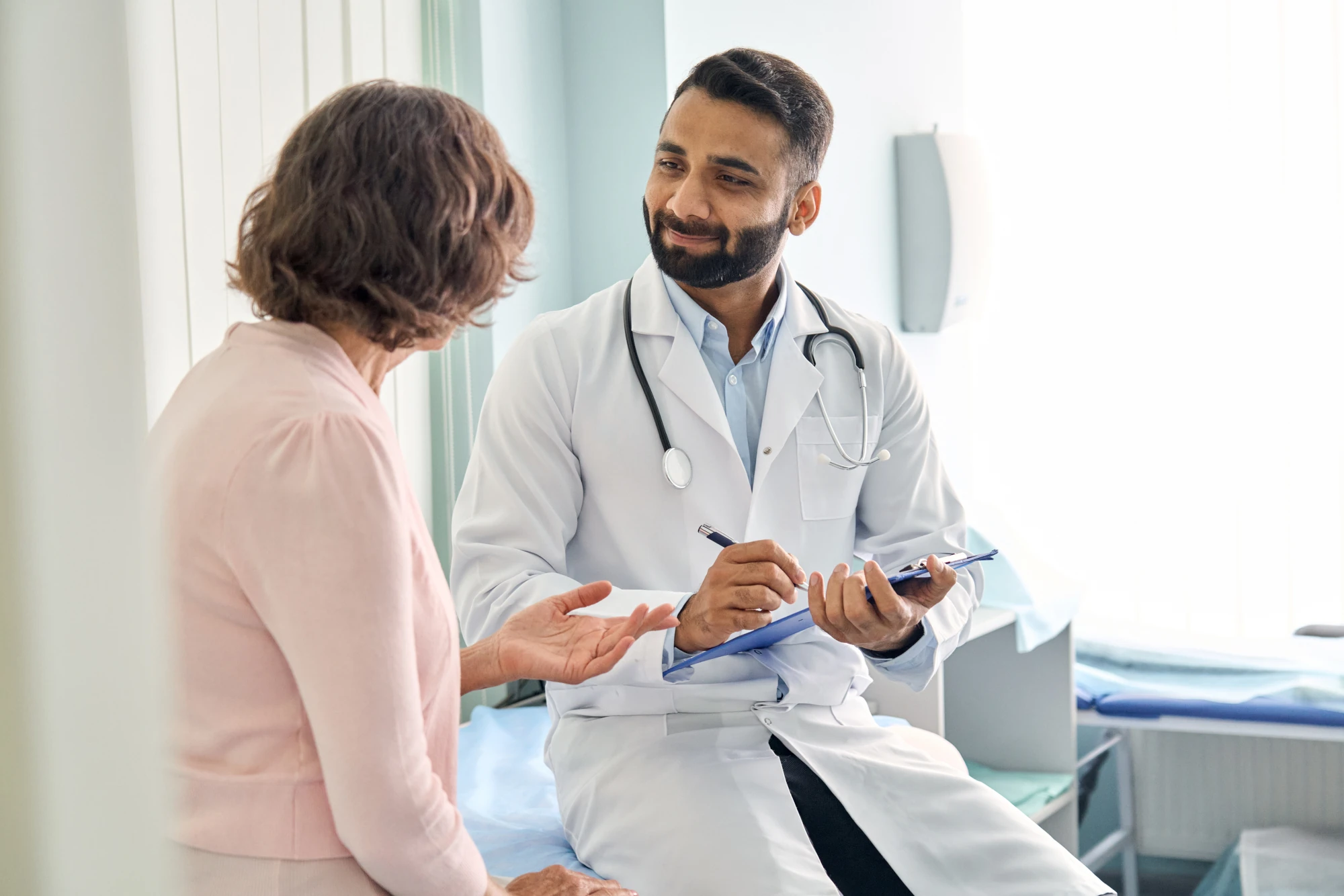 Healthtopia primary care provider in San Diego reviewing a patient’s health concerns during a visit.
