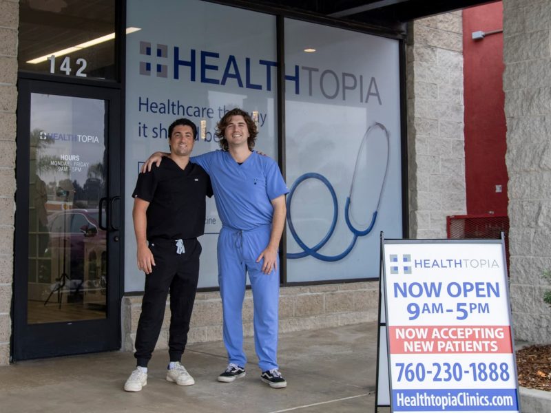 Two of our staff at the entrance of the Healthtopia Encinitas clinic